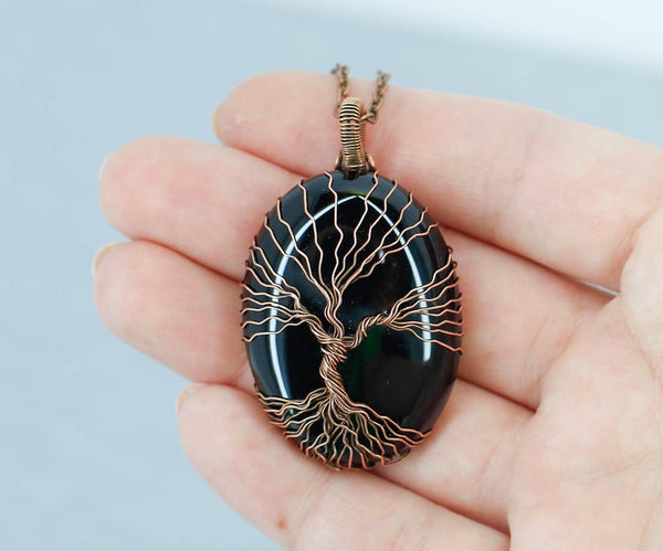 Matching black onyx tree of life necklaces for couples